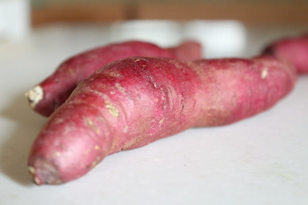 a close up of a purple carrot on a table