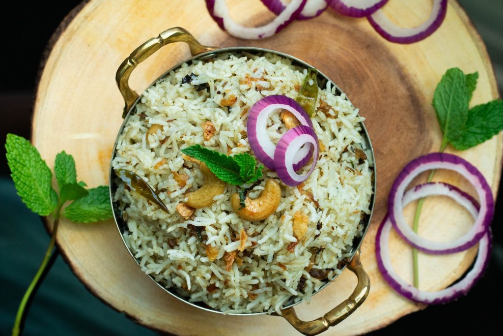 a plate of rice with onions and onions